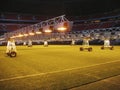 Caring for grass lawn. Lighting installation on soccer stadium Royalty Free Stock Photo