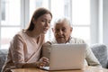 Caring grownup daughter teaching elderly father to use laptop Royalty Free Stock Photo