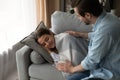 Caring husband cover sleeping on sofa beautiful wife with plaid