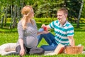 Caring husband offers to his pregnant woman apple Royalty Free Stock Photo