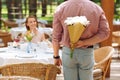 Caring husband presenting nice flowers to wife