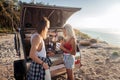 Caring loving man pouring some hot tea for girlfriend living in trailer together