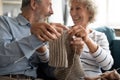 Caring loving older wife teaching husband knitting close up