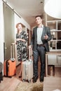 Husband and wife caring their luggage while entering hotel room Royalty Free Stock Photo