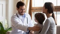 Caring male doctor cheer little boy patient a checkup Royalty Free Stock Photo