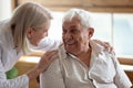 Caring nurse talking to elderly patient 80s man Royalty Free Stock Photo