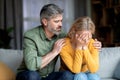 Caring Middle Aged Man Comforting His Depressed Crying Wife At Home Royalty Free Stock Photo