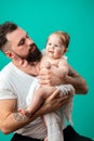 Playful father carrying his smiling infant child on neck over blue background Royalty Free Stock Photo