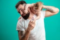 Playful father carrying his smiling infant child on neck over blue background Royalty Free Stock Photo