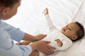 Caring Mom Doing Massage To Cute Little Black Baby Lying On Bed Royalty Free Stock Photo