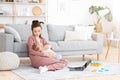 Caring Mom Nursing Baby While Working With LAptop And PApers At Home Royalty Free Stock Photo