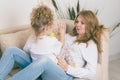 Caring mother amuses her daughter. Happy family concept Royalty Free Stock Photo