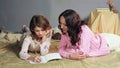 Caring mother helping her young daughter to write greeting letter to Santa Claus Royalty Free Stock Photo