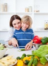 Caring mother and her son cooking