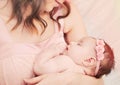 Caring mother holding with love her little cute sleeping baby gi Royalty Free Stock Photo