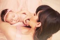 Caring mother holding with love her little cute sleeping baby gi Royalty Free Stock Photo