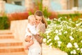 Caring mother showing plants to her baby