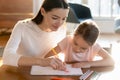 Caring mother teaching little daughter drawing colorful pencils Royalty Free Stock Photo