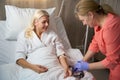 Caring nurse puts a drip with medicine on beautiful woman Royalty Free Stock Photo