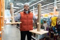 caring owner picks up a scratching post for his pet cat