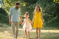 Caring parents holding hands of daughter while walking together Royalty Free Stock Photo