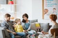 Caring parents and misbehaving boy during therapy session with counselor Royalty Free Stock Photo