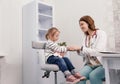 a caring pediatrician calms a little girl during an appointment in a medical office. family doctor.