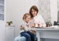 a caring pediatrician plays with a small patient soothing her during the examination.