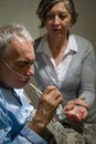 Caring senior wife holding drugs for husband Royalty Free Stock Photo