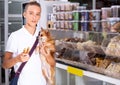Caring teenage boy choosing dog treats Royalty Free Stock Photo