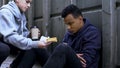 Caring volunteer boy brings dinner to homeless teenager, kind heart, charity