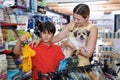 Caring woman with son buying dog clothes