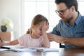 Caring young dad support upset little daughter studying