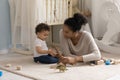 Caring young happy african ethnicity mother playing toys with kid. Royalty Free Stock Photo