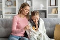 Caring Young Mom Checking Temperature Of Her Sick Child At Home Royalty Free Stock Photo