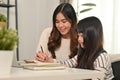 Caring young mother or tutor helping daughter doing homework during remote education. Distance education, homeschooling Royalty Free Stock Photo