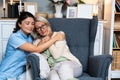 Caring young woman nurse help old granny during homecare medical visit, female caretaker doctor talk with elder lady give empathy Royalty Free Stock Photo