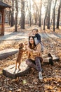 Caring for your pet in autumn, Cute English cocker spaniel puppy walking with family in autumn park.