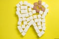 The carious tooth of sugar cubes of refined sugar, preventing tooth decay, caring for the health of your teeth Royalty Free Stock Photo