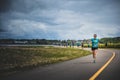 Lonely Woman Leading a Group of 10K Runners Royalty Free Stock Photo