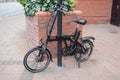 Foldable electric e-bike bicycle locked on the street