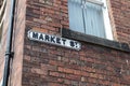 Market Street road sign on an old brick wall of a house Royalty Free Stock Photo