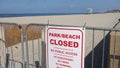 Carlsbad, CA / USA - April 21, 2020: Sign and fences restrict access to all public beaches due to Covid-19 precautions.