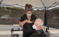 Carlsbad, CA / USA - August 24, 2020: Senior man is getting a haircut outside in times of Covid-19 Phase 2 reopening