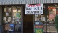 Carlsbad, CA / USA - May 11, 2020: Small restaurants advertise that they are still open for take-out and delivery with large signs