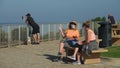 Carlsbad, CA / USA - May 2, 2020: Two women chat on a bench wearing facial coverings, which are now required in San Diego County.