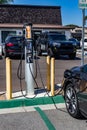 Carlsbad, California - Sept 20, 2021: Electric car plugged into a charging station in a local parking lot