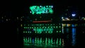 Carlsberg lighted advertising sign and river boat, Cambodia