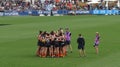 Carlton players together in a huddle before starting a game against Melbourne at Ikon Park Stadium Royalty Free Stock Photo