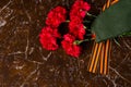 carnations, military cap and St. George ribbon, against the background of marble